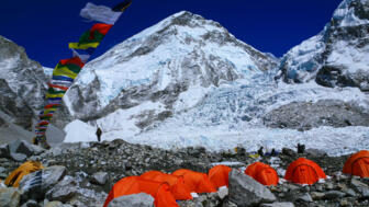 nepal-hikev-bright-color-tents-on-the-khumbu-glacier-in-area-of-everest-base-camp-with-colorful-prayer-flags-and-himalaya-mountain-range-shutterstock_765291118.jpg