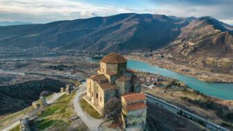 Kloster Jvari iin Georgien mit Sicht auf Fluss und braunes Hütelland