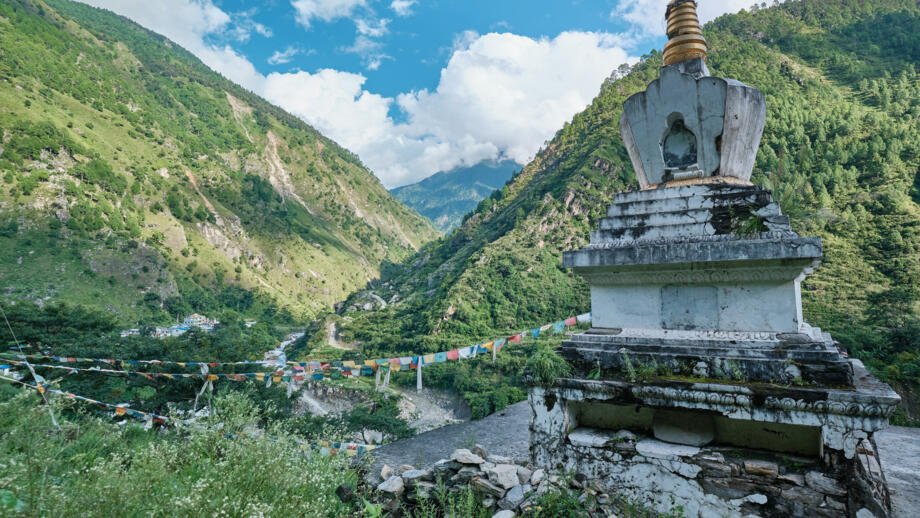 nepal-hiahl-big-white-buddhist-stupa-hanged-with-colourful-buddhist-prayer-flags-against-a-background-of-mountains-and-blue-sky-in-town-of-syabru-besi-shutterstock_1570197874.jpg
