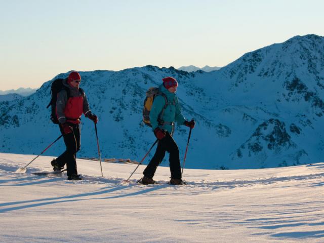 Schneeschuhwanderer in der Dämmerung