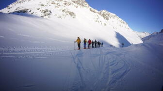 Skitourengruppe auf dem Weg zu einem Gipfel nahe Jamtalhütte
