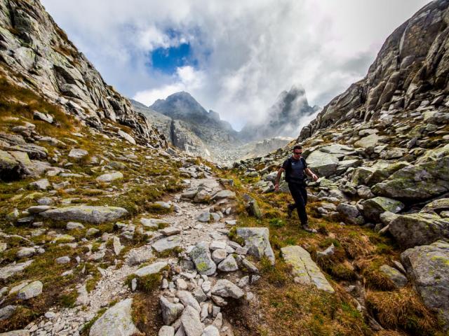 Bergsteiger beim Abstieg auf steinigem Weg