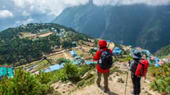 nepal-hiahg-trekker-looking-below-to-view-of-namche-bazaar-village-in-khumbu-shutterstock_1627571863.jpg