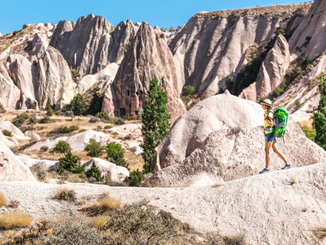 Junge Frau wandert im Pasabag Valley in Kappadokien vor Felsformationen